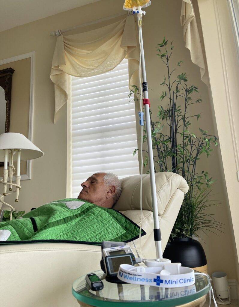 grey haired man in a chair getting an infusion